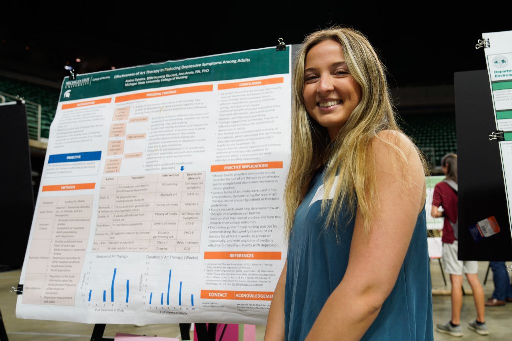 Nursing fourth-year Alaina Dykstra in front of her UURAF poster on April 14, 2023.