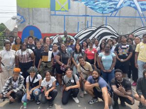 MSU Detroit 2023 group photo in front of mural. 