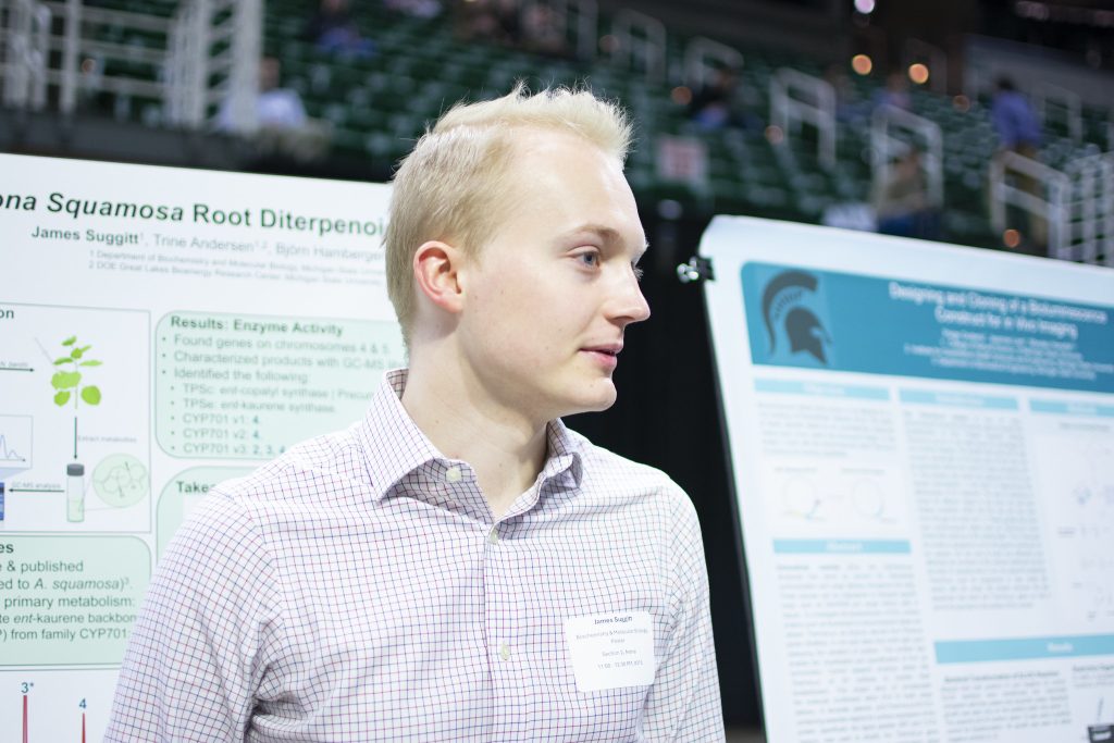 James Suggit speaking in front of his UURAF poster