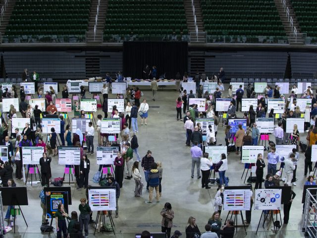 wide shot of the various student poster presentations at the Breslin Center for UURAF