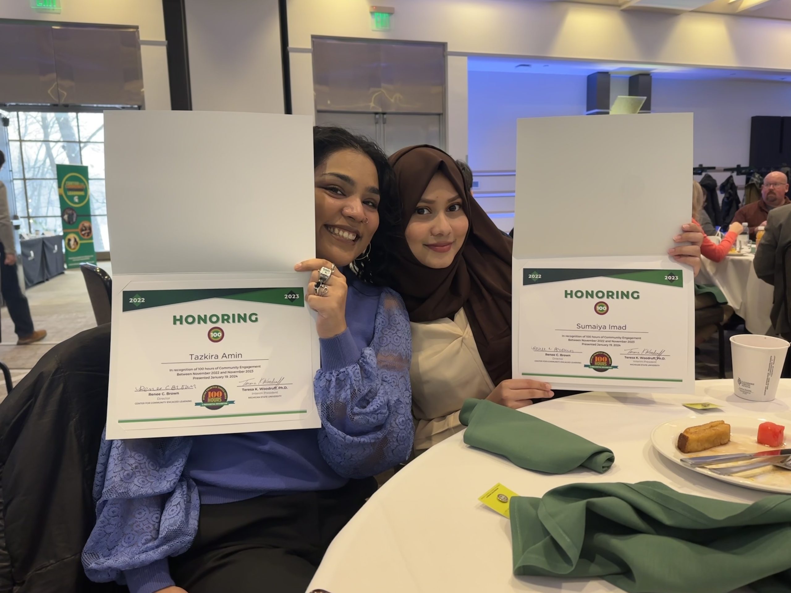 Imad accepting the Spartan Volunteer Service Award with a friend. 