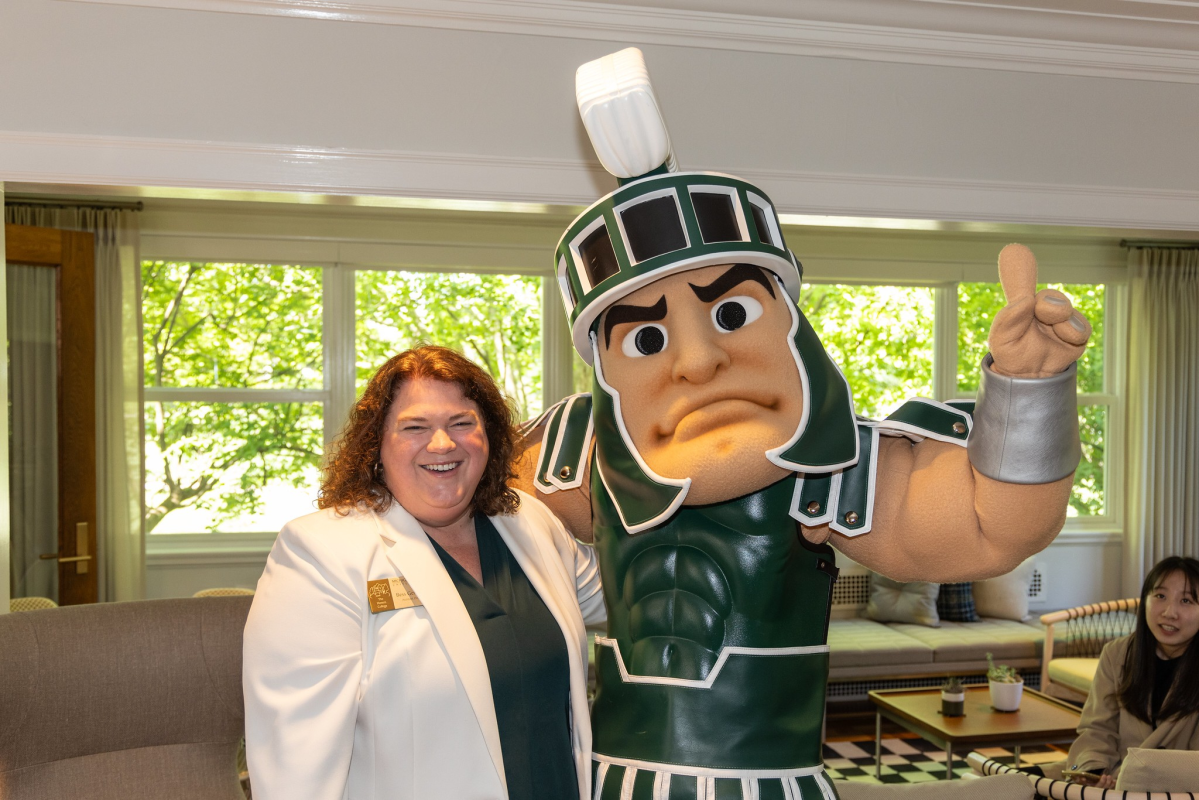 Assistant Dean Bess German posing with Sparty at the Campbell Hall groundbreaking ceremony in 2024