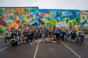 Group photo of IMPACT participants, mentors, and staff in front of Allen Neighborhood Center.