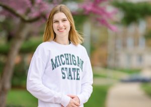 Caroline Beckrow headshot wearing MSU-branded clothing. 