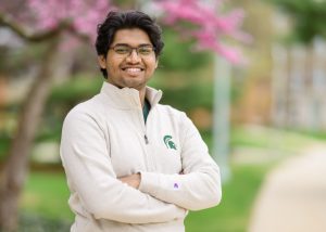 Om Nair headshot wearing MSU-branded clothing. 