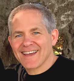 Image of Professor Marcos Dantus smiling in a black t-shirt.