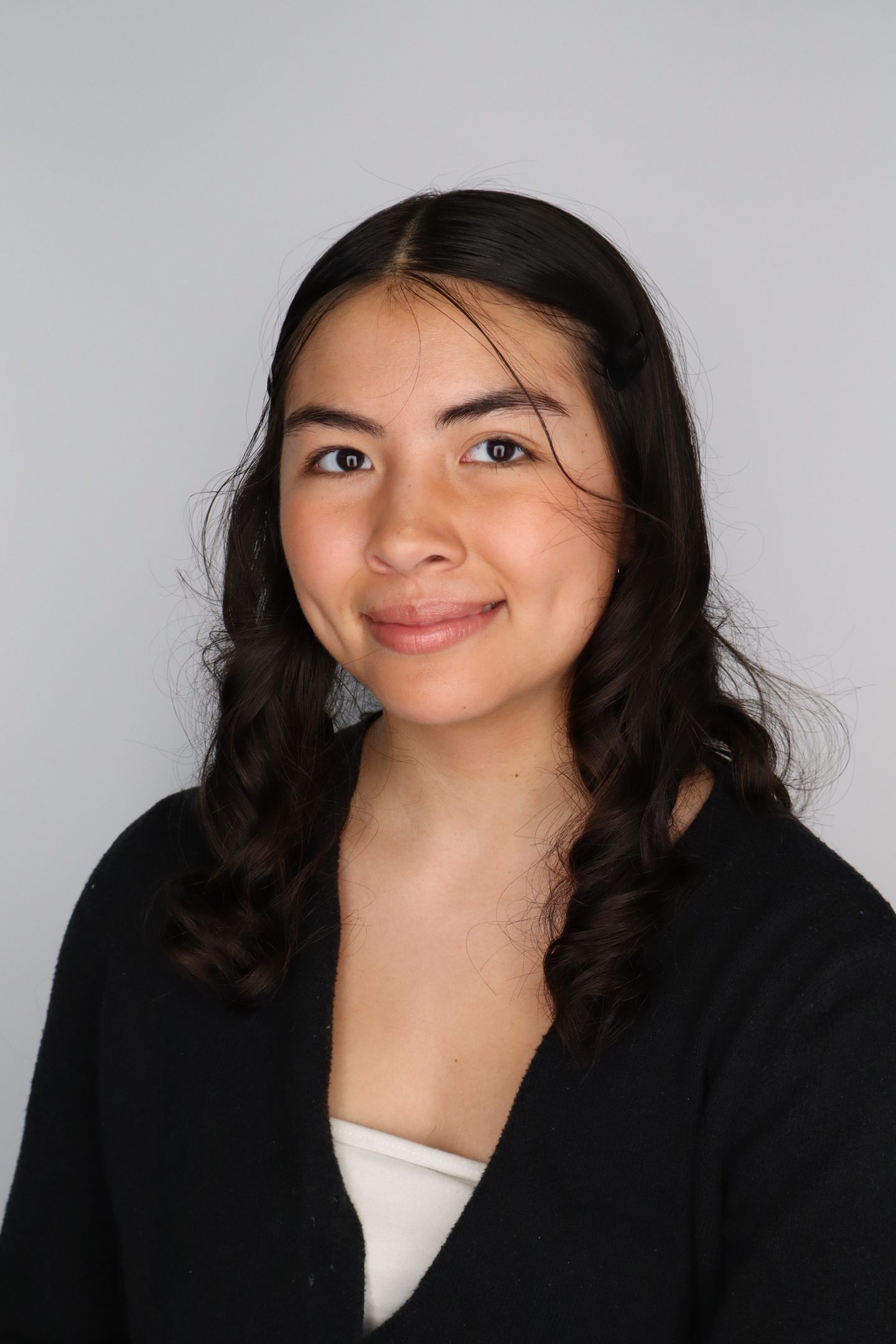Professional image of Audrey Dayton softly smiling in a black top, against a neutral background.