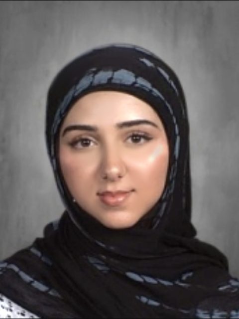 Image of incoming MSU Honors College student and Alumni Distinguished Scholar Fatima Hammoud softly smiling in a grey and black hijab against a grey gradient background.