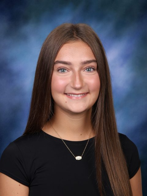 Professional image of incoming MSU Honors College student and Williams Scholar Layla Bajric smiling in a black shirt against a blue gradient background.