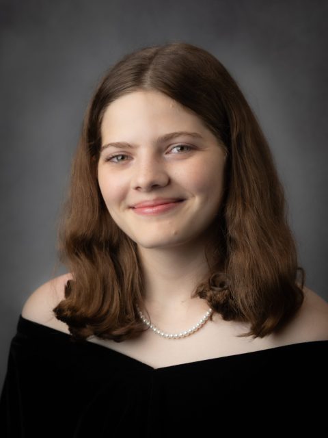 Professional image of incoming MSU Honors College student and Williams Scholar Laurel Howard wearing a pearl necklace and black top, smiling against a grey gradient background.