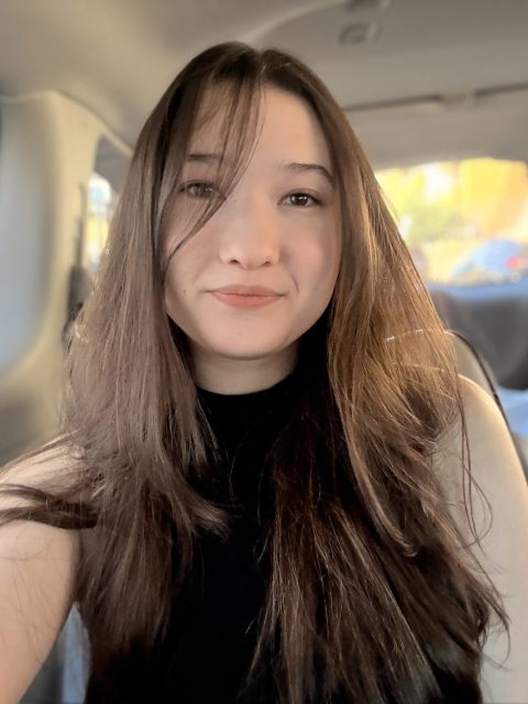 Image of incoming MSU Honors College student and Williams Scholar Natalie Olinger taking a selfie inside a car, wearing a black top.