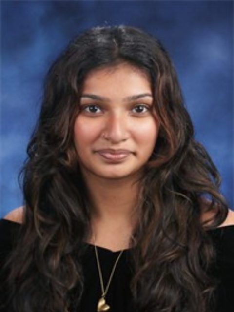 Professional image of incoming MSU Honors College student and Williams Scholar Simrin Rao with a neutral expression, wearing a black top against a blue gradient background.